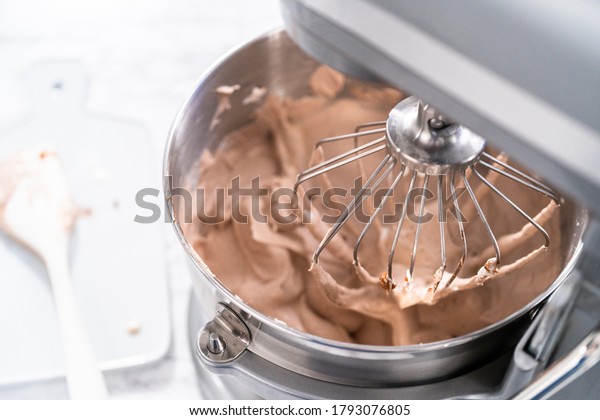 Mixing ingredients in a standing kitchen mixer\
to make homemade chocolate ice\
cream.