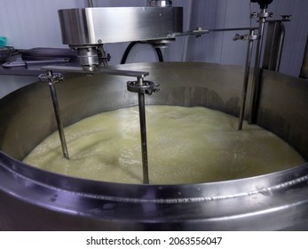 Mixing Milk In A Cheese Factory In A Large Vat. Cheese Production In A Small Cheese Factory