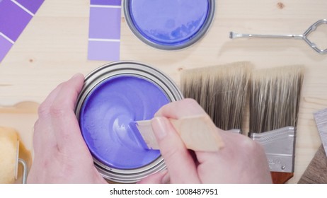 Mixing New Purple  Paint With Wooden Paint Stick.