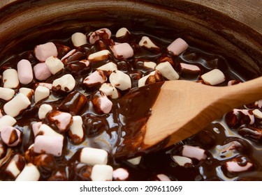 Mixing Pink And White Mini Marshmallows Into Dark Chocolate For Rocky Road Treats