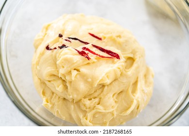 Mixing Red And Blue Food Coloring Into The Cake Dough.