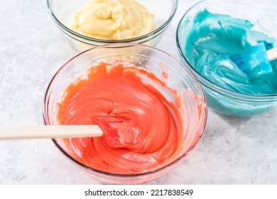 Mixing Red And Blue Food Coloring Into The Cake Dough.