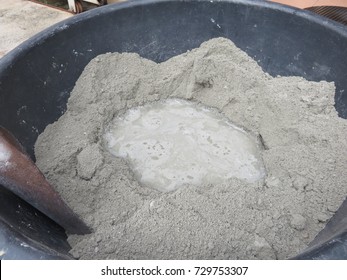 Mixing of sand, water, and Portland cement in powder form which is a basic ingredient of concrete, mortar, stucco, and most non-specialty grout and is a substance used in construction