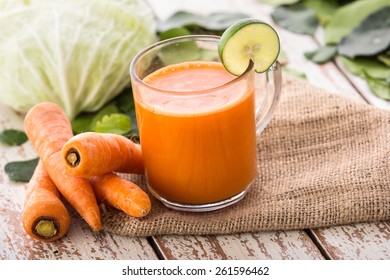 Mixing two ingredient, carrot, cabbage and kale into a juicy healthy juice