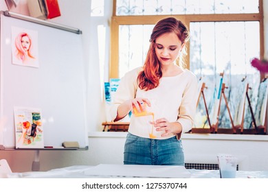 Mixing Watercolor. Appealing Young Talented Art Student Mixing Watercolor While Painting