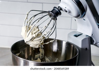 Mixing Whipped Cream in a Stand Mixer with a Whisk Attachment: Heavy whipping cream mixed with a stand mixer wire whisk