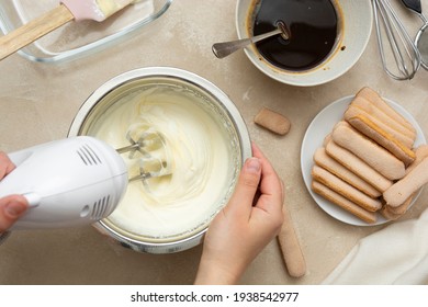 Mixing, whipping cream for cake. Cooking tiramisu cake with sponge fingers. Step by step recipe.