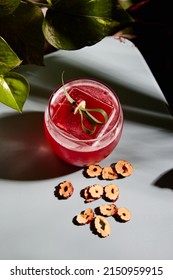 Mixology Red Cocktail Surrounded By Plants