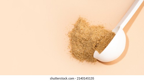 Mixture of dietary fiber supplement . White scoop of dietary fiber on a beige background. Dietary herbal supplements. Biologically active additives. Gut and stomach health concept. Copy spase. Banner.