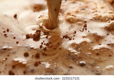 Mixture of fresh milk and cocoa powder - Shutterstock ID 2233117131