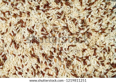 A mixture of a plurality of different types of rice. The texture of the surface of the rice.