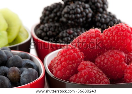 Mixture of summer fruit in black and red bowls
