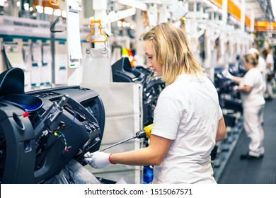Mlada Boleslav, Czech Republic - September 20 2019: SAS Automotive Systems plant, cockpit production for SKODA AUTO, young woman on assembly line
