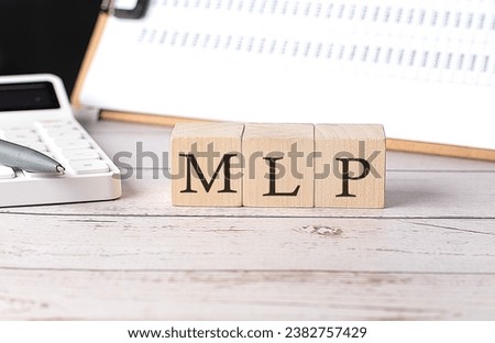 MLP - Master Limited Partnership word on wooden block with clipboard and calculator
