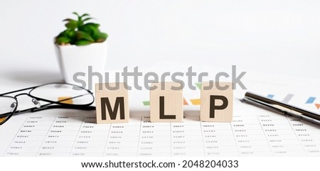 MLP - Master Limited Partnership written on a wooden cube on the chart background