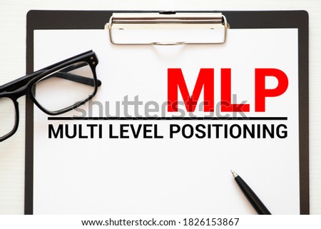MLP- Multi Level Performance written on paper on wooden background.