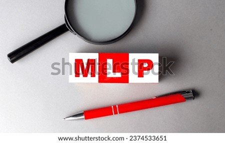 MLP word on a wooden cubes with pen and magnifier