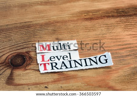 MLT- Multi Level Training written on paper on wooden background
