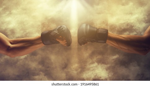 Mma fight, close up of two fists hitting each other over dark, dramatic sky with copy space.