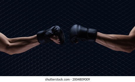 Mma fight, close up of two fists hitting each other over dark background