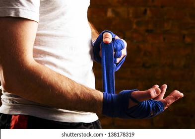 mma fighter is getting ready against brick wall - Powered by Shutterstock