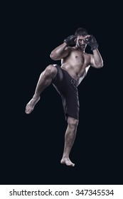 Mma Fighter Hitting With Knee Isolated On Black Background