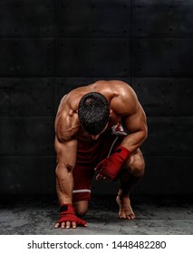 MMA Fighter Kneeling on the Floor Before the Fight