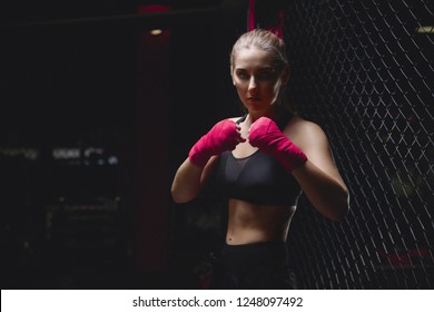 MMA Girl In Sports Uniform Ready To Fight Boxing Ring Defense Of Women From Violence, Pink Bandages On His Fists, Combat Readiness