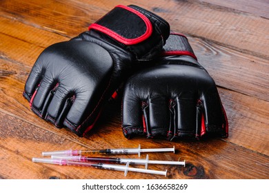 mma gloves and steroid medication composition on a wooden background