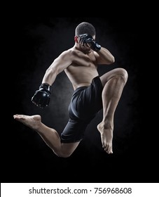 mma male fighter jumping with a knee kick