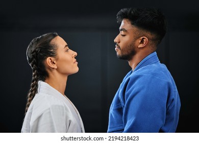 Mma, Martial Arts And Self Defense Training Or Practice With A Man And Woman Having A Face Off In Studio Against A Black Background. Man And Woman In Gi Or Uniform Ready To Fight In Combat Sport