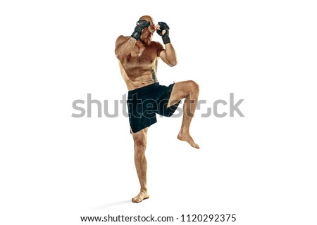 MMA. The professional boxer boxing isolated on white studio background. Fit muscular caucasian athlete fighting. Sport, competition, excitement and human emotions concept