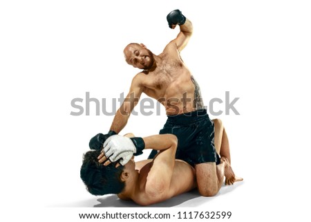 MMA. Two professional boxers boxing isolated on white studio background. Couple of fit muscular caucasian athletes fighting. Sport, competition, excitement and human emotions concept