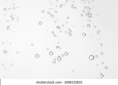 Mnay Small Shiny Water Bubbles Flowing Over A White Background