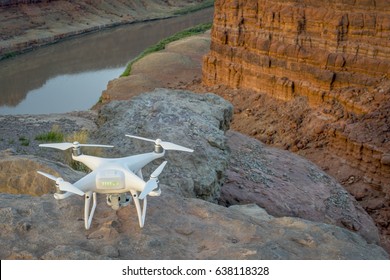 MOAB, UT, USA - MAY 7, 2017:  DJI Phantom 4 Pro Drone Is Ready To Take Off In The Canyon Of Colorado River For Sunrise Photography.