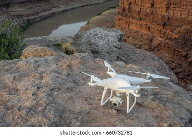 MOAB, UT, USA - MAY 7, 2017:  DJI Phantom 4 Pro Drone Is Ready To Take Off In The Canyon Of Colorado River For Sunrise Photography.