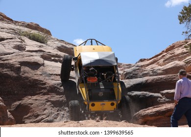 Moab Utah, USA,April 23,2019: Yellow Buggy Climbing Up The Widow Maker Obstacle On The Metal Masher 4x4 Off Road Jeep Trail.