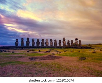 Moai Statues With Colorful Clouds On Easter Island On Sunset. Ahu Tongariki Against Blue Sky, Chile, South America