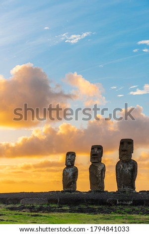 Moai statues at sunrise in vertical format with copy space, Ahu Tongariki, Easter Island (Rapa Nui), Chile.