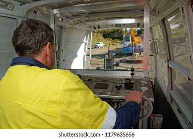 MOANA, NEW ZEALAND, OCTOBER 27, 2017: An Oil Well Engineer Works From The Back Of Specialised Van To Log The Condition Of Steel Casing Inside An Abandoned Oil Well. 