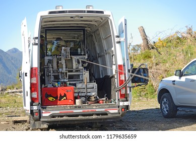 MOANA, NEW ZEALAND, OCTOBER 27, 2017: An Oil Well Engineer Works From The Back Of Specialised Van To Log The Condition Of Steel Casing Inside An Abandoned Oil Well. 