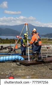 MOANA, NEW ZEALAND, OCTOBER 27, 2017: The Safety Officer Sets Up A Rescue Tripod At The Top Of An Abandoned Oil Well Before Sending Workers Into A  Confined Space.