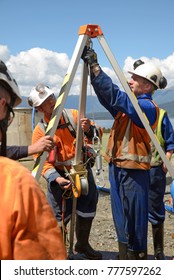 MOANA, NEW ZEALAND, OCTOBER 27, 2017: The Safety Officer Sets Up A Rescue Tripod At The Top Of An Abandoned Oil Well Before Sending Workers Into A  Confined Space.