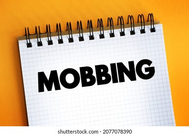 Mobbing - sociological term, means bullying of an individual by a group, text on notepad - Shutterstock ID 2077078390