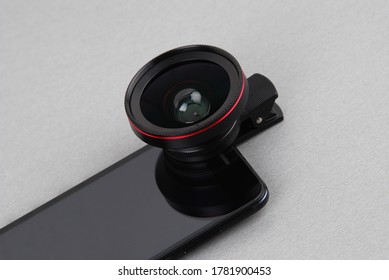 mobile accessories clip lens wide mounted on a black mobile phone with a gray background 