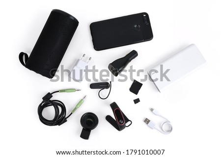 Mobile accessories includes power bank, speaker, charger, smart watch, handsfree, AUX cable, microSD, adapter and macro clip lens flat lay