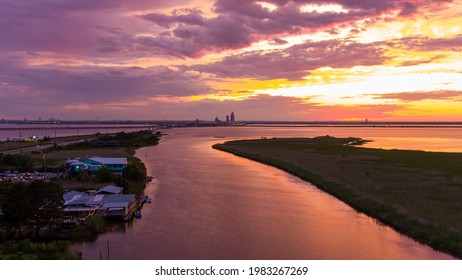 Mobile, Alabama USA 29 May 2021 The Original Oyster House And The Bluegill Restaurants On The Mobile Bay Causeway At Sunset