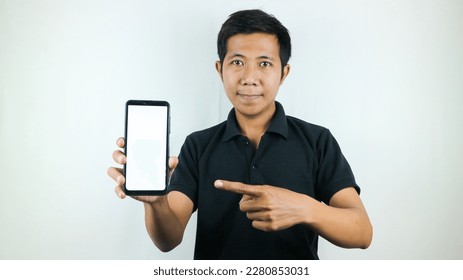 Mobile App Advertisement. Asian Man hold At White Empty Smartphone Screen Posing Over White Studio Background, Smiling To Camera. Check This Out, Cell Phone Display Mock Up - Shutterstock ID 2280853031