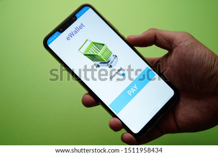 A mobile app eWallet conceptual with mock up apps and men hand holding phone