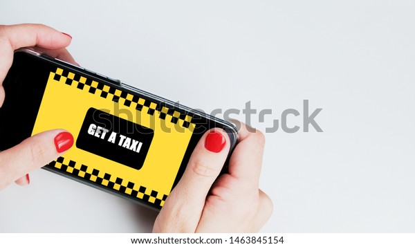 Mobile application order taxi service, online\
car service concept. Woman hands holding  smartphone with mobile\
application order taxi service. Phone screen with button \